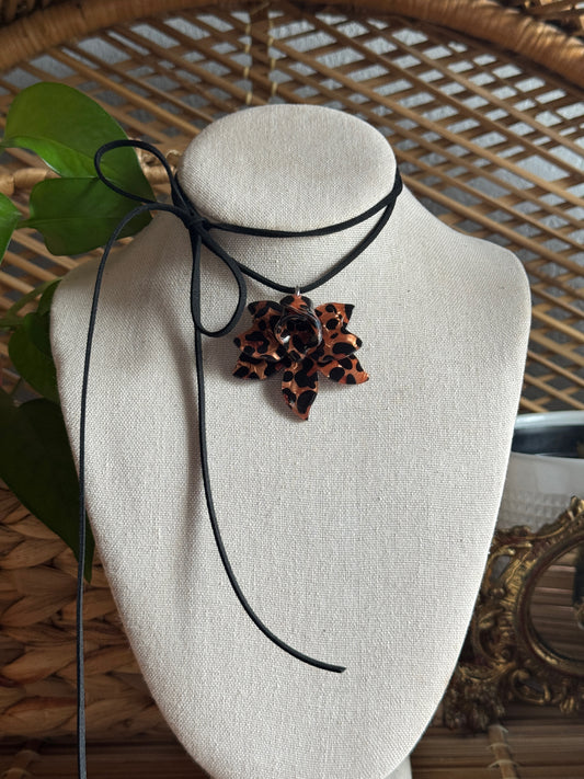 tortoise flower black suede cord necklace